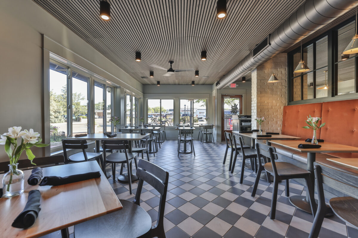 Inside view of a room at Olives full of tables and chairs