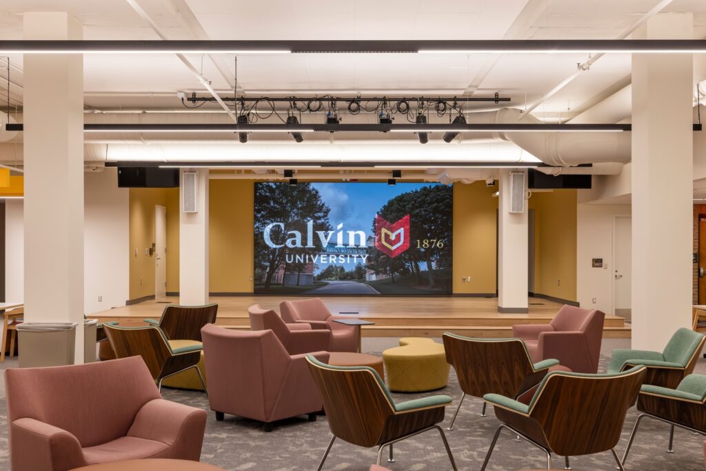 Interior shot of Calvin University — Hekman Library and Hiemenga Hall with chairs and a stage