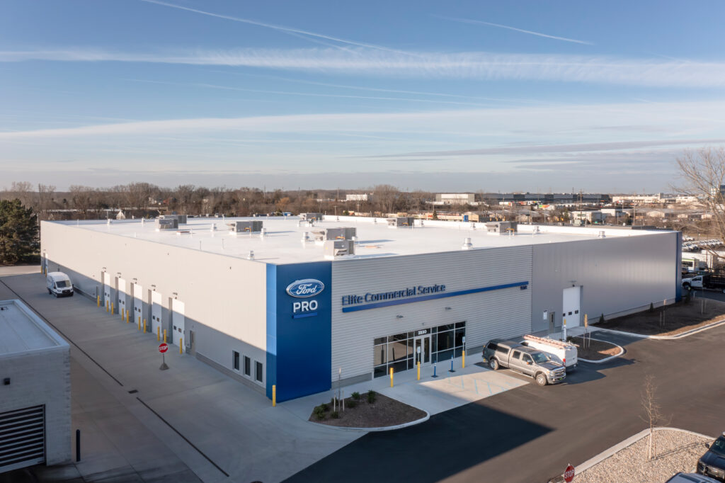 outdoor birds-eye-view of Fox Ford Commercial Pro Center, white building with blue accents.