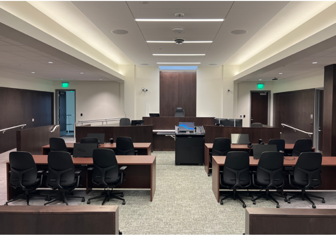 Main courtroom interior showcasing benches and chairs.