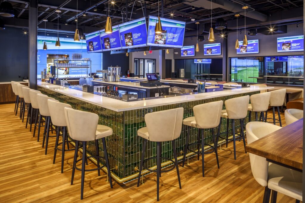 Here's an improved version: Interior view of a bar area with screens and alcohol display