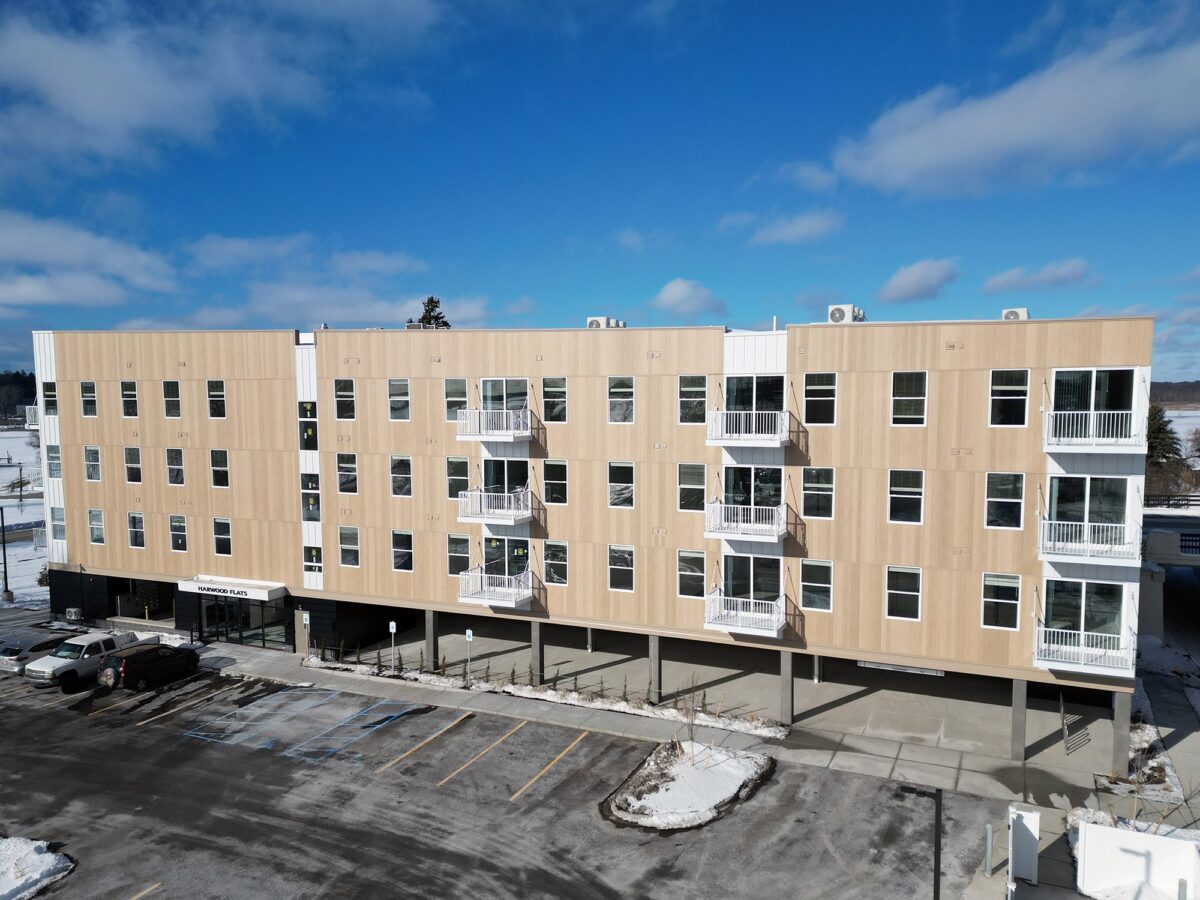 An exterior look at the Hardwood Flats featuring windows and balconies.