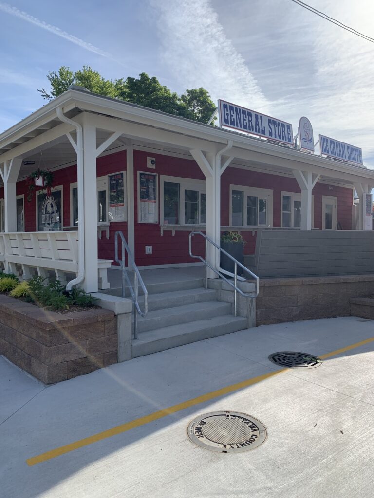 Exterior photo of Ottawa Beach General Store front entrance showcasing the stairs