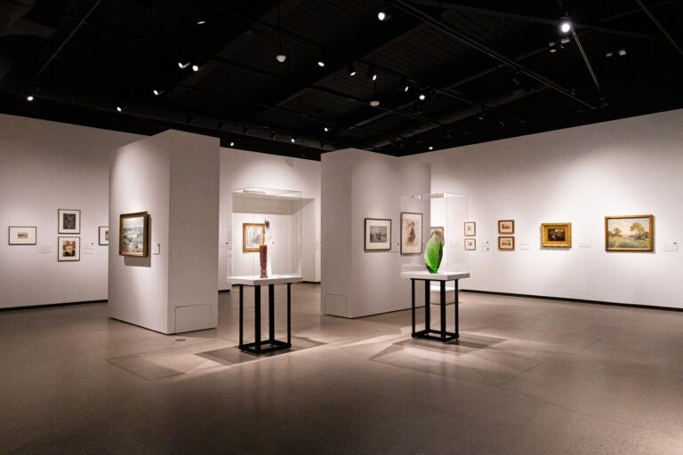Interior of Muskegon Museum of Art showcasing art on the walls and statues in the middle